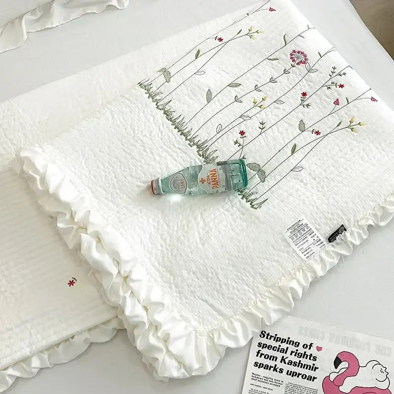 White quilted cotton quilt set with fresh flower embroidered ruffled edges in soft reds greens and yellows decorbites fresh flower