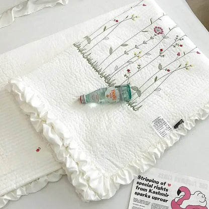 White quilted cotton quilt set with fresh flower embroidered ruffled edges in soft reds greens and yellows decorbites fresh flower