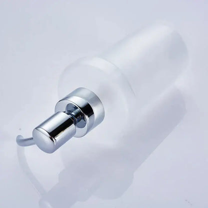 White frosted glass liquid soap dispenser with chrome finish and gold pump for bathroom use