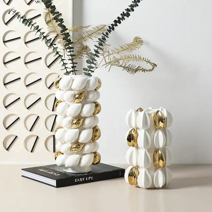 White ceramic vase with gold metallic accents and textured lemon carambola design for living room decor