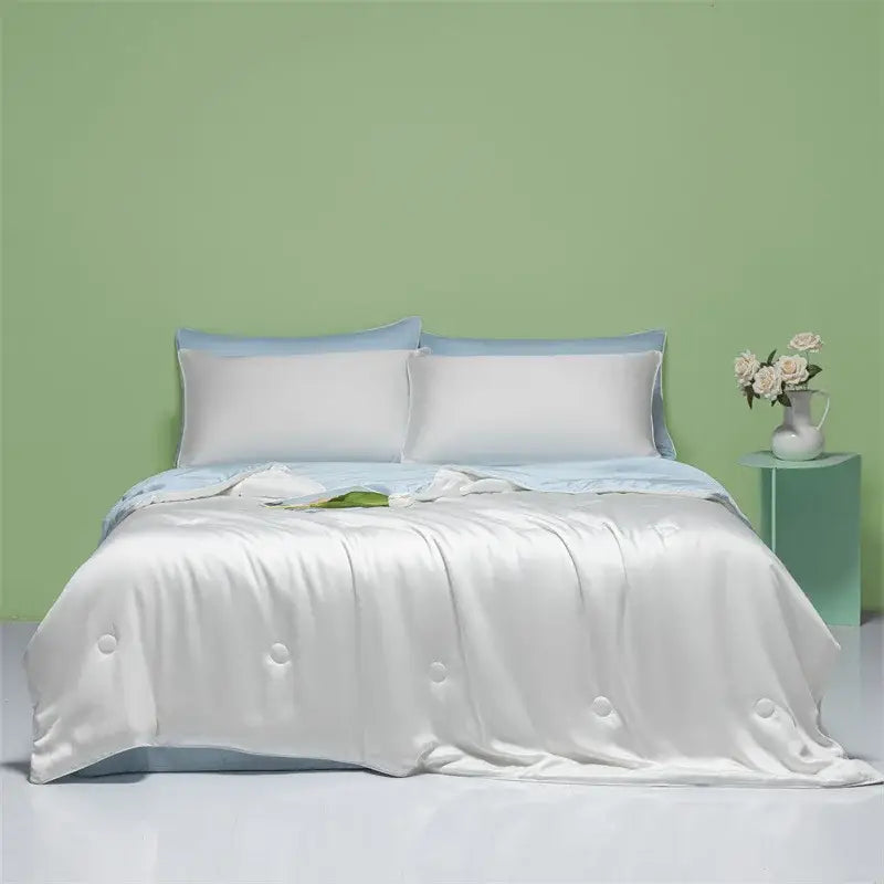 White satin duvet cover with subtle button detailing and light blue pillowcases in decorbites cool feel summer quilt bedroom