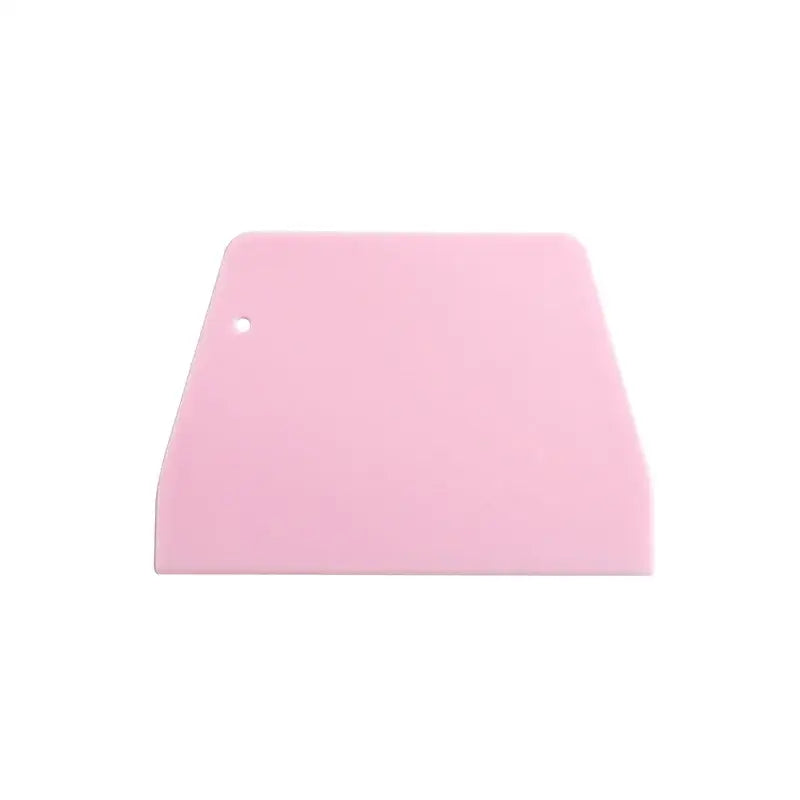 Pink silicone cake cutter spatula with rounded top edge and hole for dough cream cake and cream cake cutter use