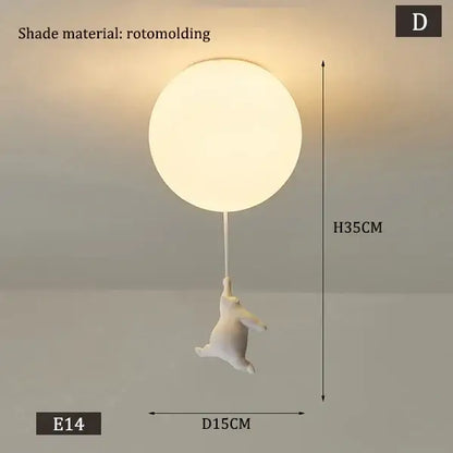White polar bear ceramic pendant light with white rotomolded spherical shade and dangling bunny figurine cord pendant