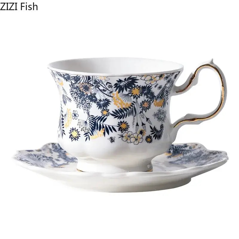 Elegant white porcelain classic tea cup with navy and gold floral pattern and gold accented curved handle
