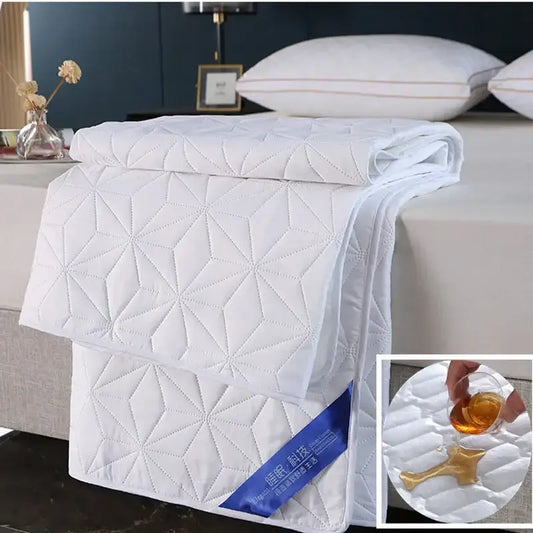 White quilted bed protector pad with geometric star pattern and stitched detailing for bedroom use