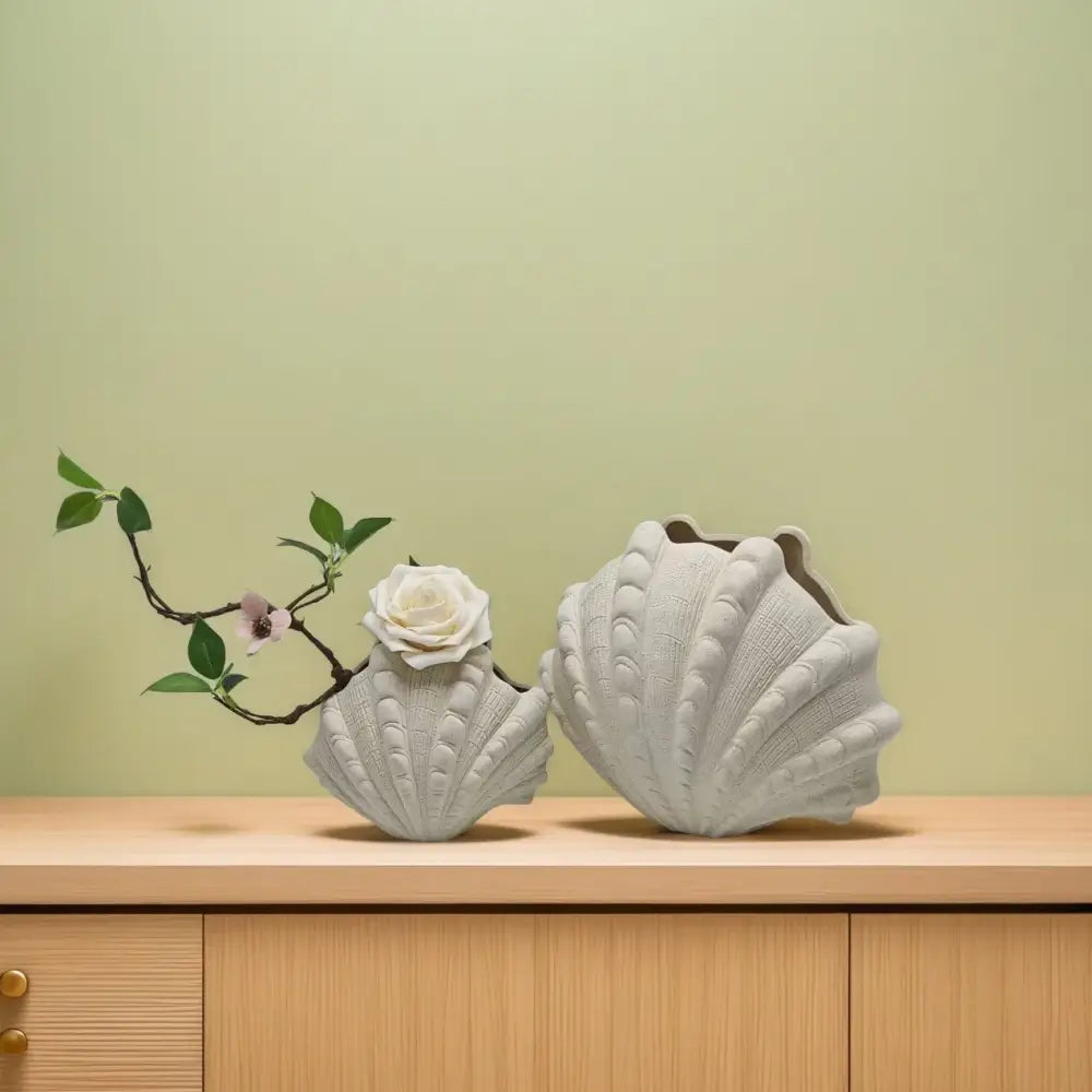 Two white ceramic clam shell vases with textured ridged surfaces for living room decor by decorbites ceramic clam