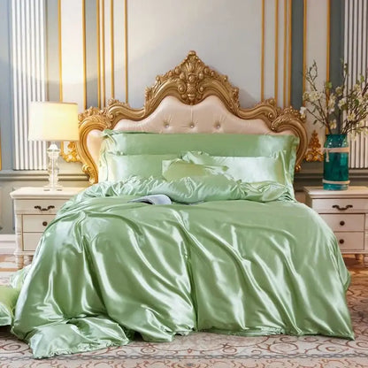 Luxurious sage green satin four-piece duvet cover set with matching pillowcases and sham in white satin silk blend