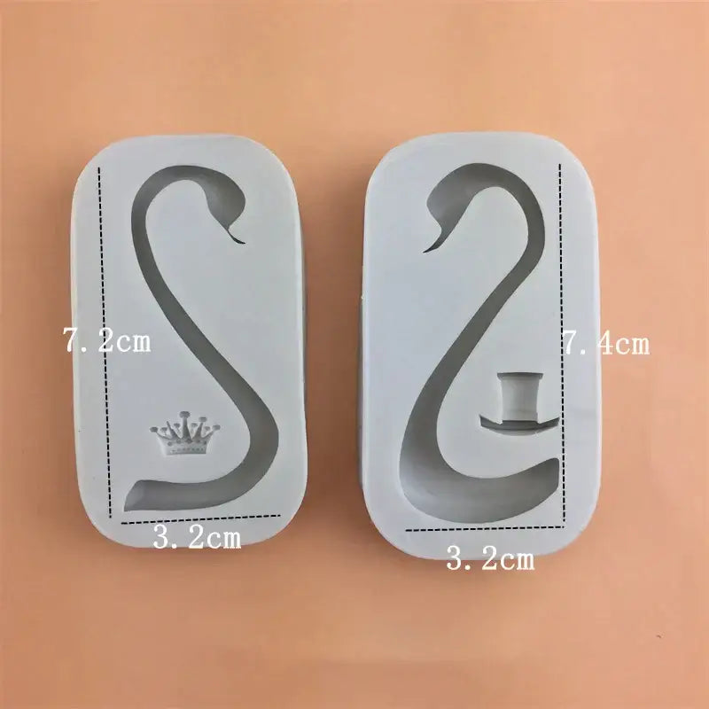 Two white silicone cake molds shaped like swans with crown and top hat for swan neck decorbites 3d wings decoration