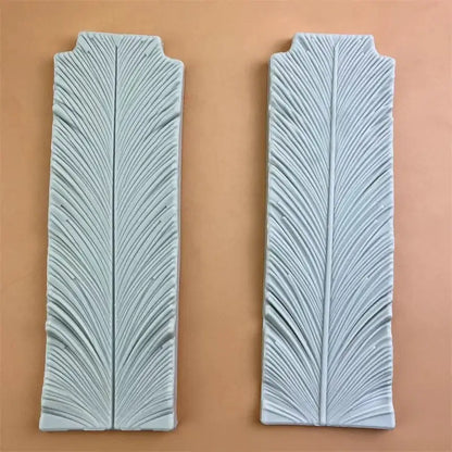 Two light blue ceramic tiles with detailed feather-like relief pattern for white silicone 3d wings cake mold swan neck decorbites 3d wings
