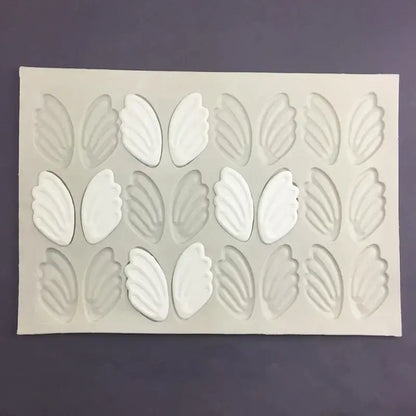 White silicone cake mold with three rows of detailed swan neck decorbites 3d wings cavities for decoration