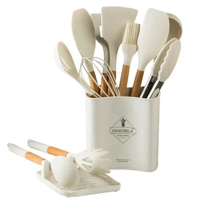 Cream-colored silicone kitchen cookware set with wooden handles neatly organized in a matching cylindrical holder container