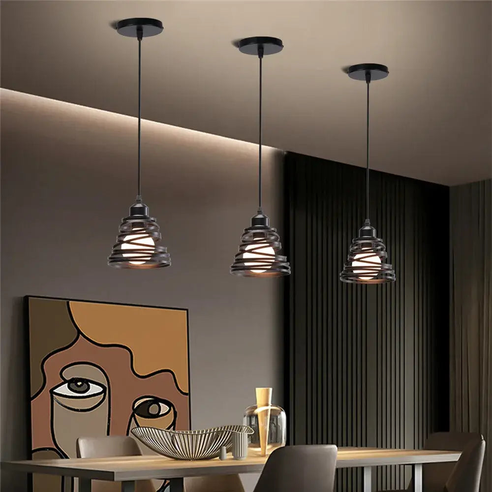 Three black industrial-style decorbites iron cage pendant lights with spiral iron cage ring shades for kitchen decor