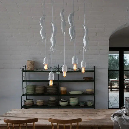 White ceramic squirrel pendant light with exposed filament bulbs as a decorative focal point for bedrooms