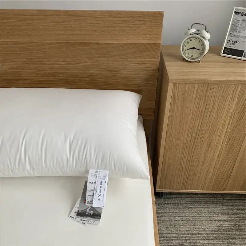 White textured cotton rectangle neck pillow with soft plush texture resting on bed for bedroom bedding