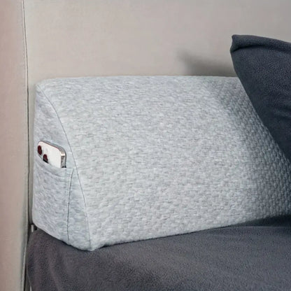 Gray textured fabric pillow wedge with built-in pocket holding smartphone for decorbites headboard pillow wedge use