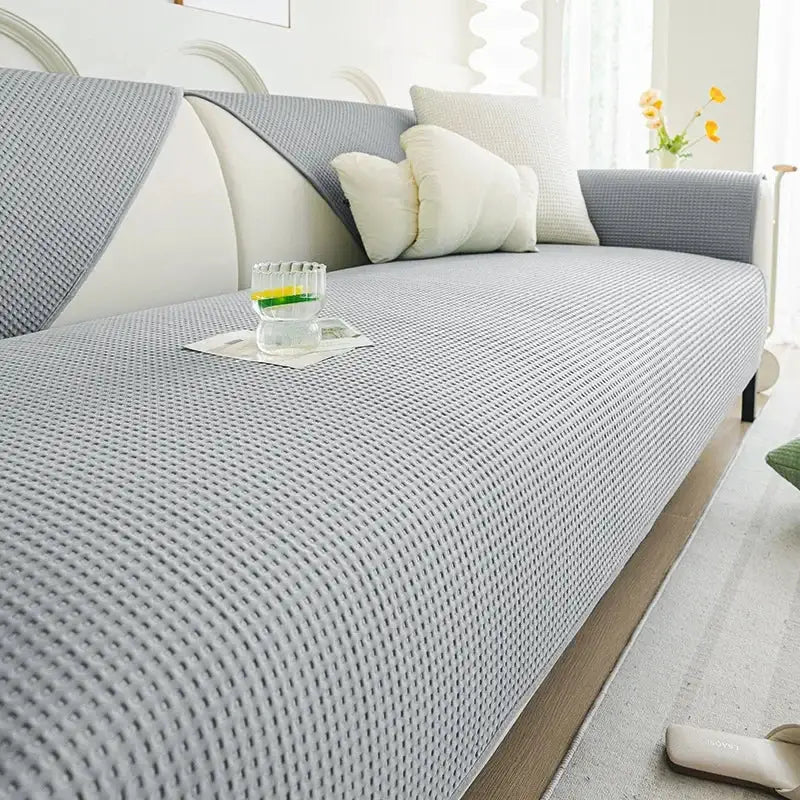 Gray textured sofa cover with woven pattern and matching gray and white pillows in white waffle weave ice silk living room cushion