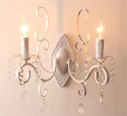 White wrought iron wall lamp with ornate scrollwork and dangling crystals decorbites crystal deco loft sconce