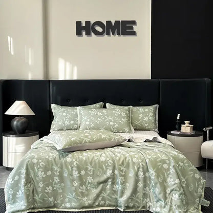 A soft sage green satin quilt set with white floral pattern featuring decorbites cool silk summer bedding