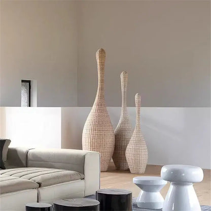 Three tall slender rattan vases in natural beige color enhancing decorbites bamboo floor lamp modern living room decor