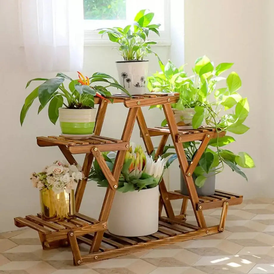 DecorBites 6-tier wooden plant stand with natural finish and slatted shelves holding various potted plants