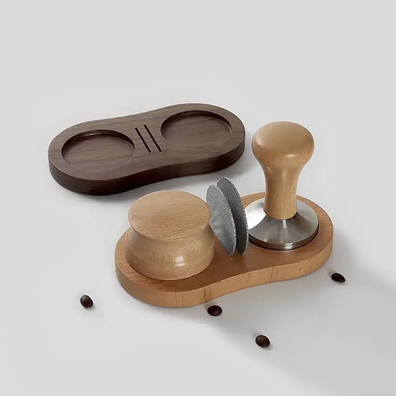Light wood espresso distributor tamper and portafilter holder set with stainless steel puck screen on dark brown tray