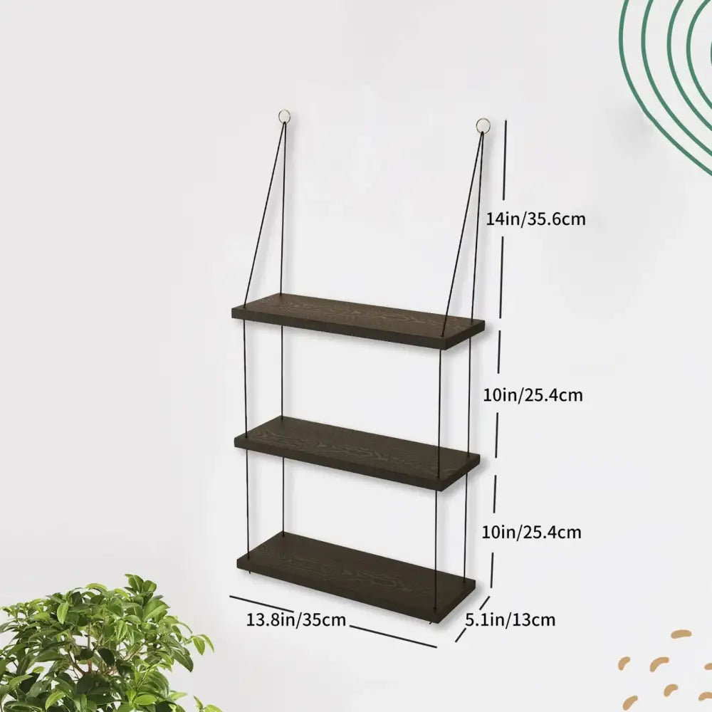 Dark brown wood floating shelf with three tiers suspended by black cords for boho decor by decorbites