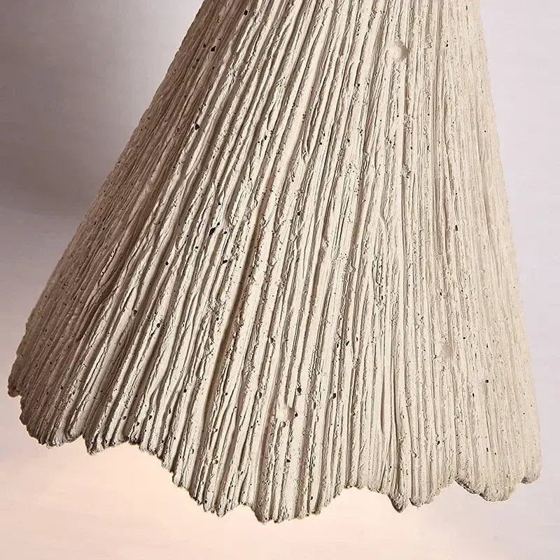 Off-white textured concrete pendant light with vertical ridges and scalloped edge decorbites designer pendant light