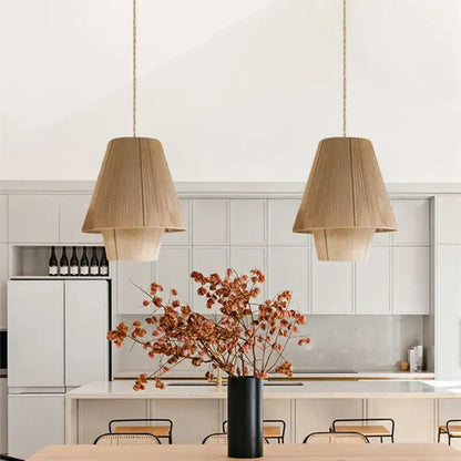 Black cylindrical vase with dried orange brown floral branches beside decorbites handmade hemp rope pendant lamp kitchen light