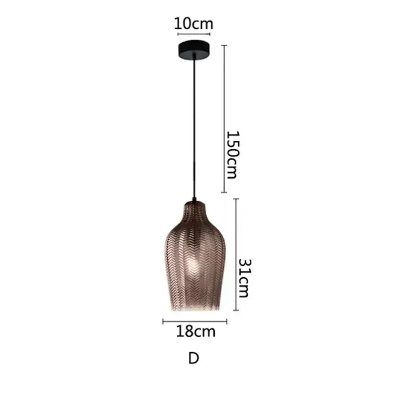 A modern glass pendant light with copper-toned woven chevron pattern shade for kitchen and dining room lighting