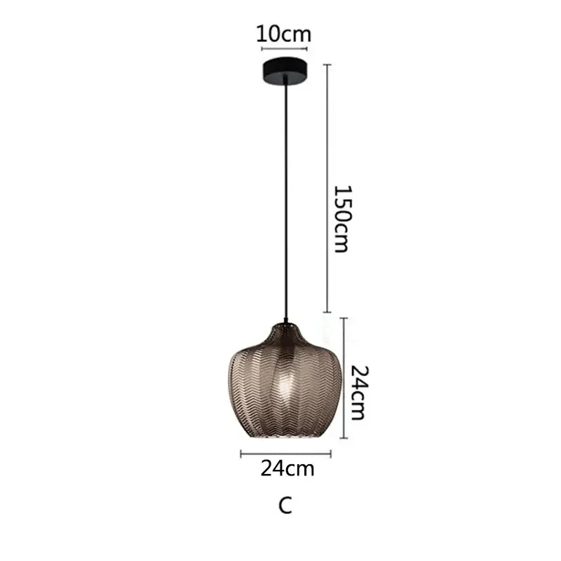 Modern glass pendant light with textured dark bronze shade and black hardware for kitchen and dining room use