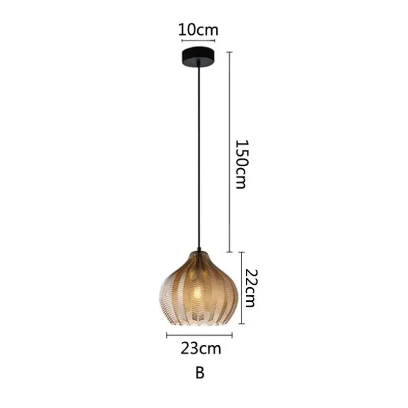 A modern black and amber glass pendant light with vertical ridges for kitchen and dining room lighting