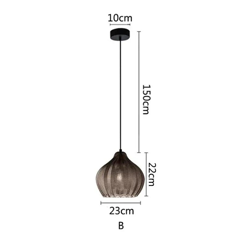 A modern black nordic style pendant light with woven textured glass shade and sleek metal chain for kitchen use