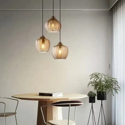 Three warm-toned ribbed woven gold glass pendant lights for kitchen and dining room ceiling installation