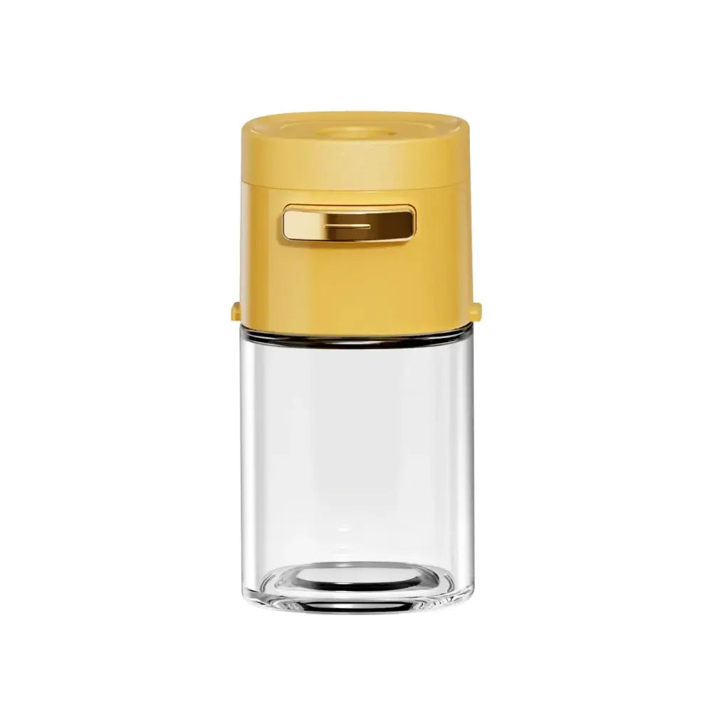 Yellow and clear glass spice dispenser with vibrant yellow lid and gold-tone handle for kitchen salt grinding