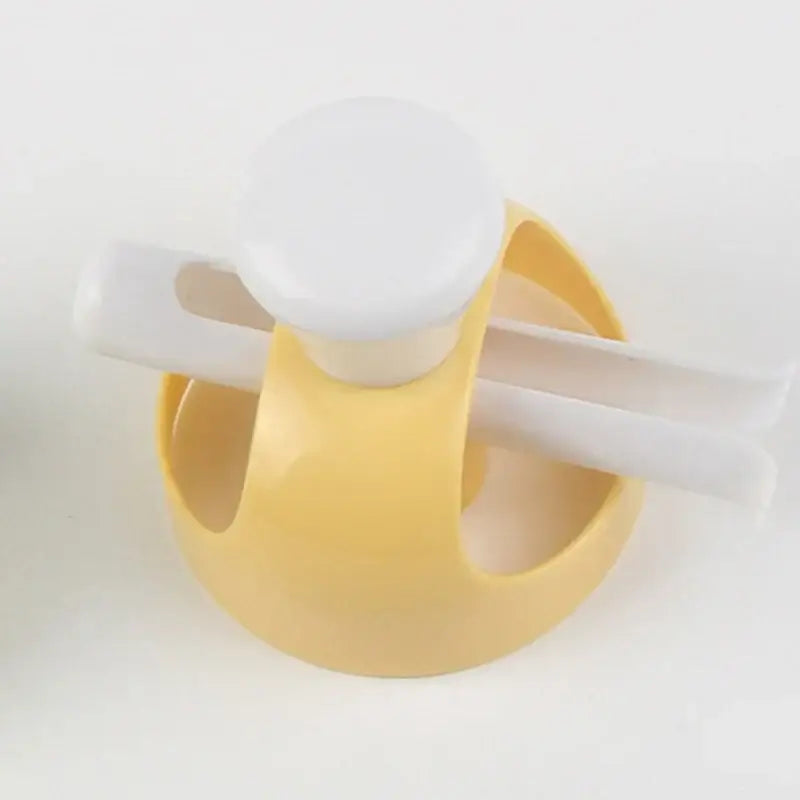 Yellow plastic baby bottle feeder with white cap and handle included in yellow and white donut cutter baking tools kit