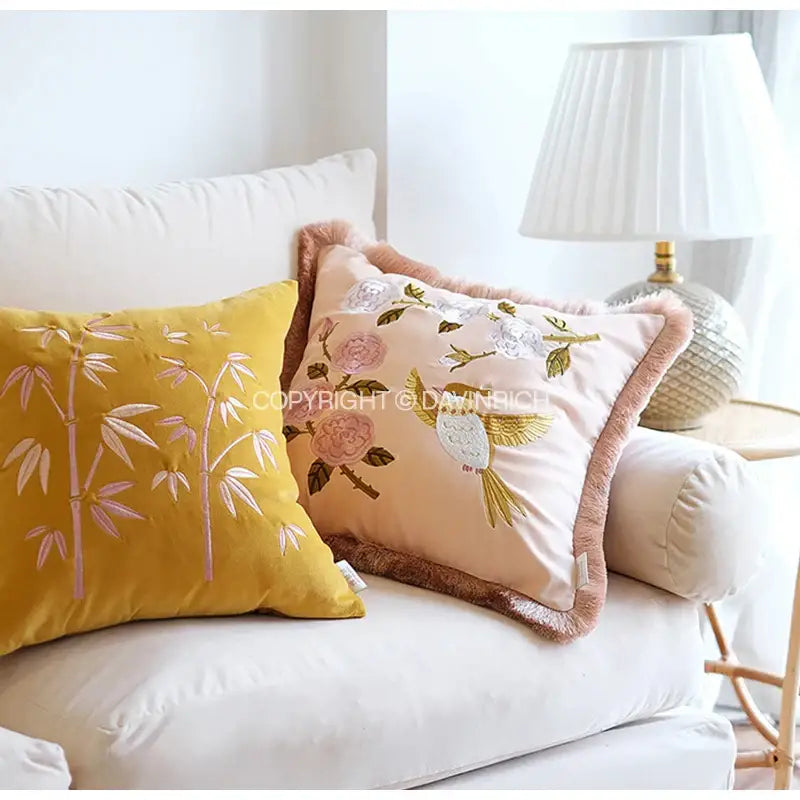 Soft peach throw pillow cover with floral bird embroidery and brown fringe trim for yellow bamboo velvet bedroom decor