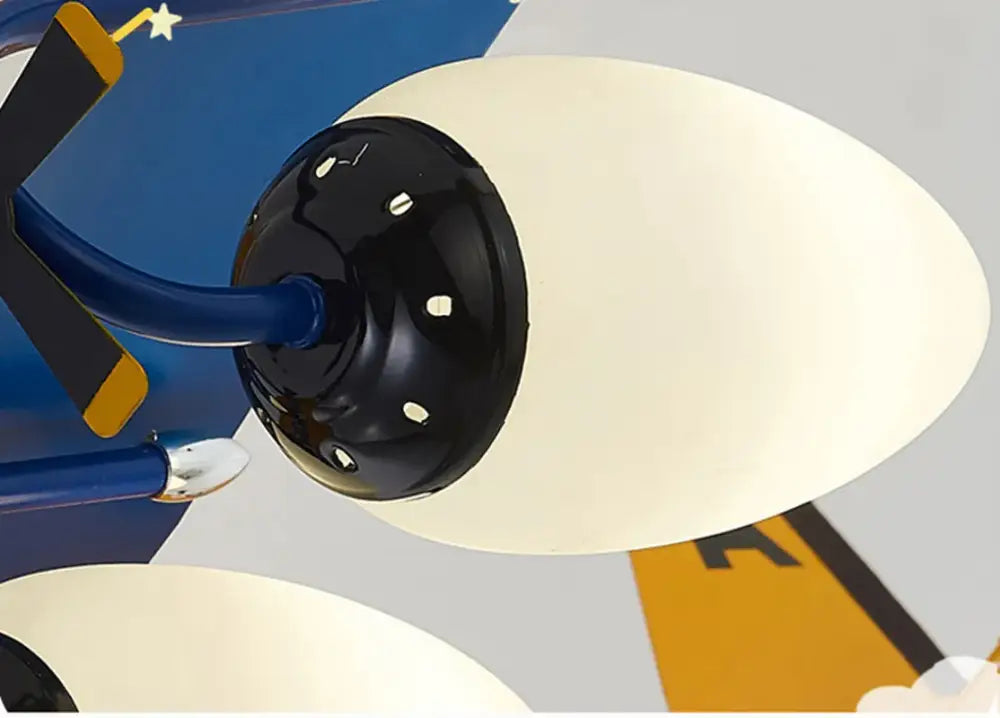 Cream-colored oval lampshade with glossy black dotted base in yellow and blue airplane bluetooth speaker lamp for kids room decorbites bluetooth speaker