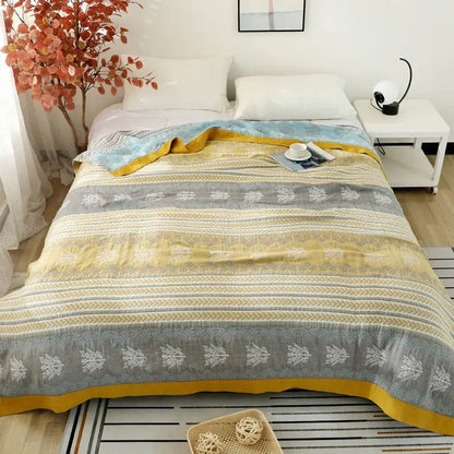 Cozy yellow and gray cotton stripe gauze towel quilt with white botanical patterns and mustard-yellow border for summer use