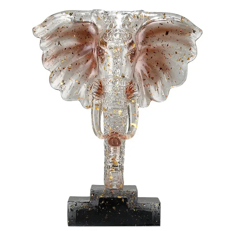 Yellow and blue crystal elephant sculpture with transparent glass and gold leaf accents on dark base for home decor by decorbites