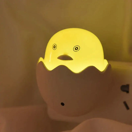 Yellow chick in eggshell led night light glowing yellow chick shape with cracked eggshell base for bedroom use