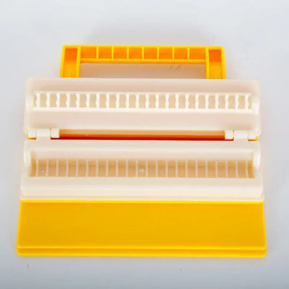 Yellow and white plastic sushi roll maker with handle for making bbq meat skewers as a meat skewer maker tool