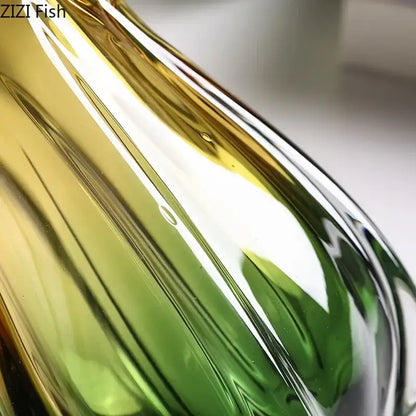 A sleek yellow and green glass vase hydroponics with gradient glass for artificial flowers in the dining room
