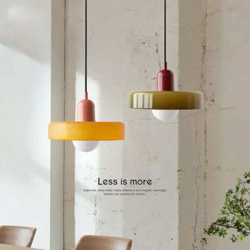 Two modern nordic canteen chandelier pendant lights with matte yellow and olive green shades and red caps for decorbites cream nordic decor