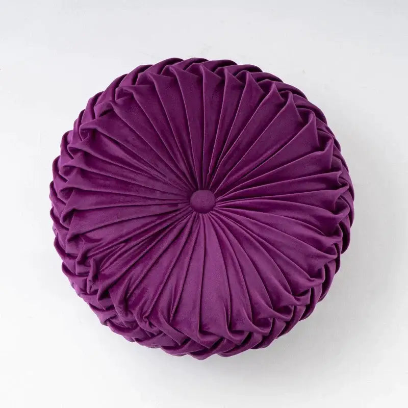 A deep purple velvet round throw pillow with radial pleated design and button ideal for decorbites 3d pumpkin decor