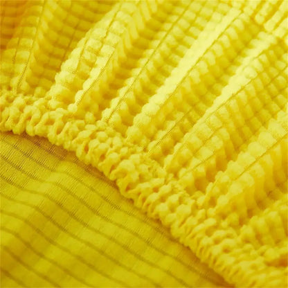 Yellow ribbed fleece chair cover made of textured stretchy knit fabric for dining room seat protection
