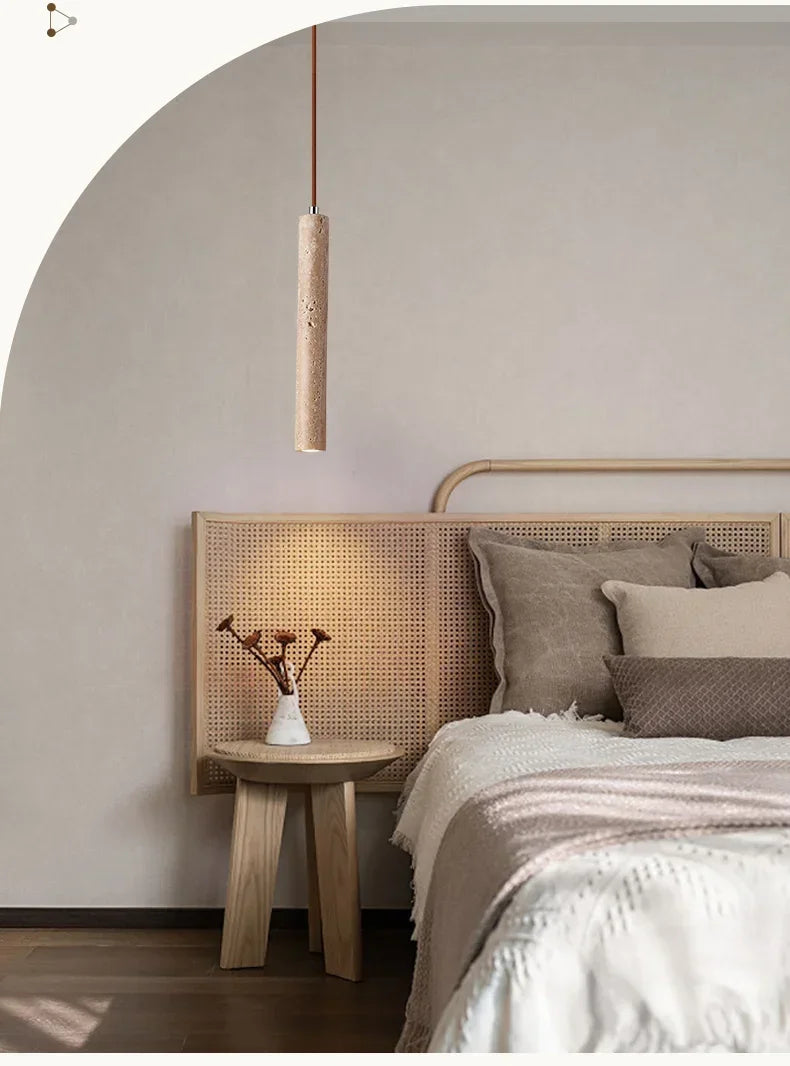Yellow stone pendant light with cylindrical textured beige rattan shade suspended by thin cord stone pendant light