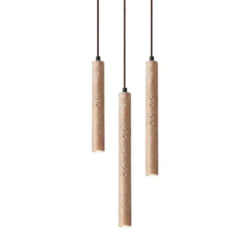 Three slender beige stone pendant lights with textured concrete surface hang from black cords for bedroom use