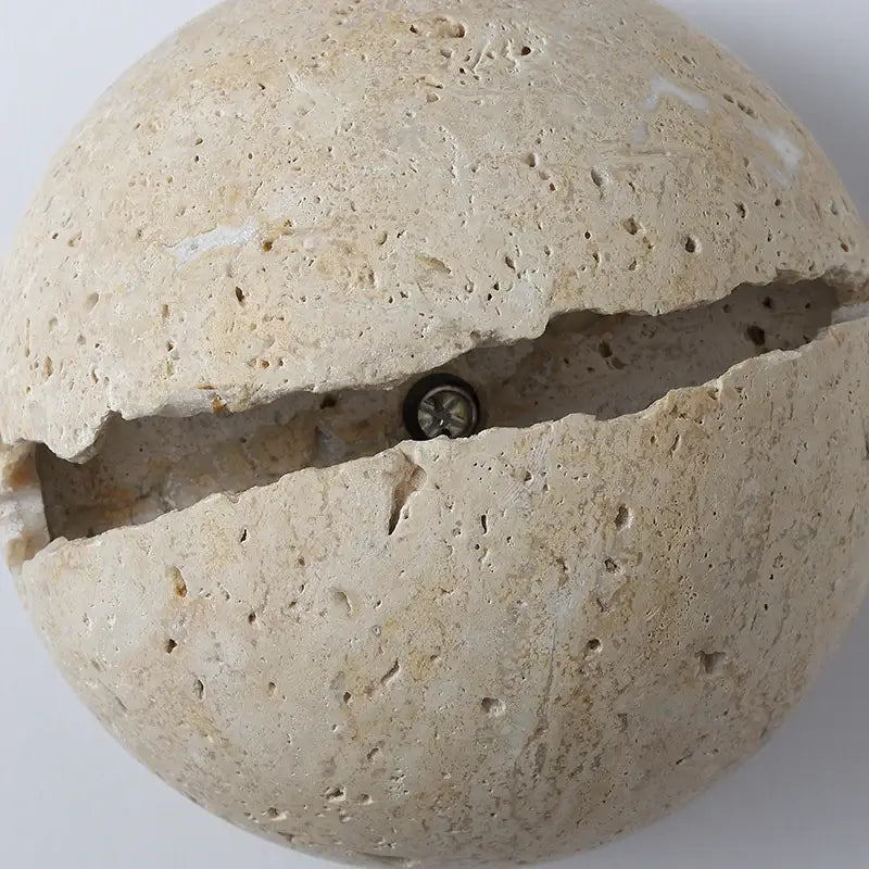 Beige yellow travertine dino egg stone wall lamp with split design and embedded bulb decorbites dino egg sconce