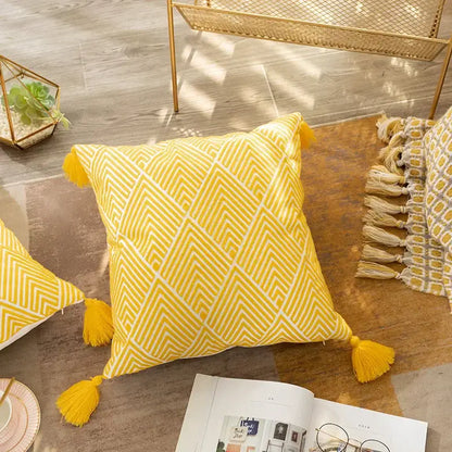 Bright yellow cushion cover with white geometric embroidery canvas and matching tassels for living room decorbites decor