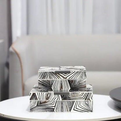 Stacked zebra black and white jewelry storage box with geometric patterns and metallic handles for desktop storage